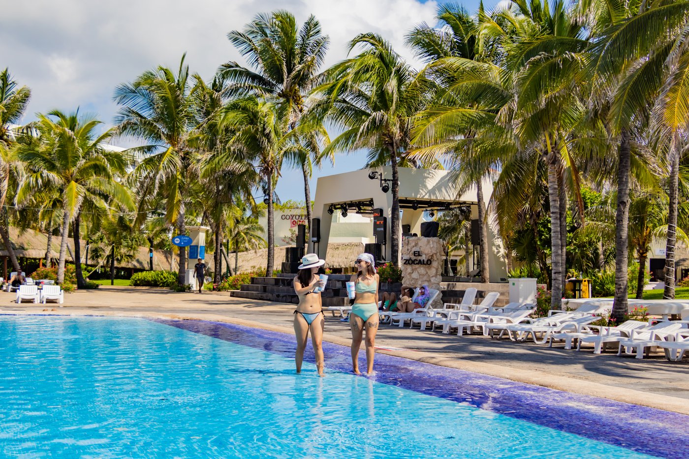 Gallery of Areas: Guests in a common area pool at the hotel Grand Oasis Cancun.