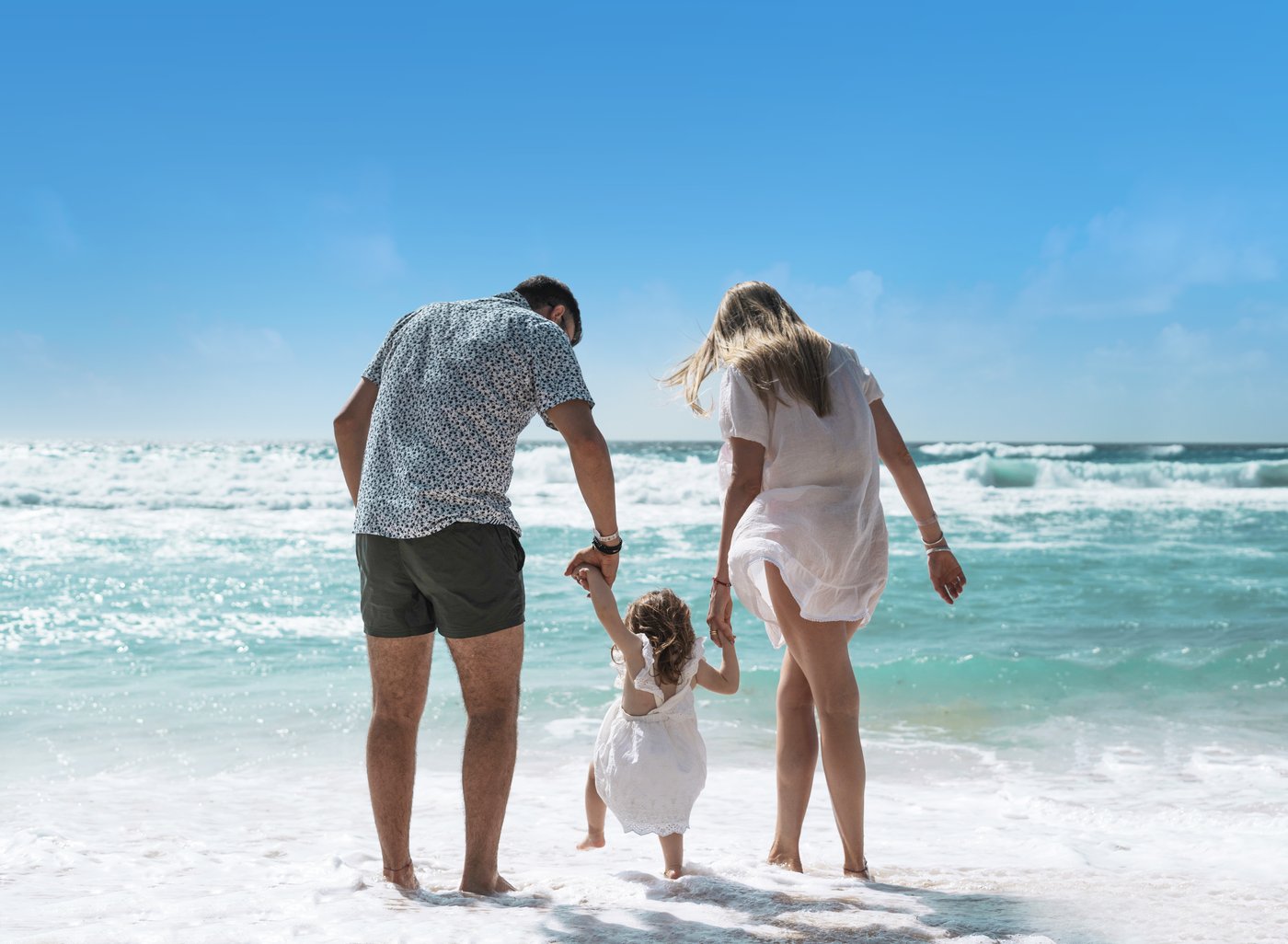 Gallery of Beach: Family walking at the water's edge of the hotel Grand Oasis Cancun beach.