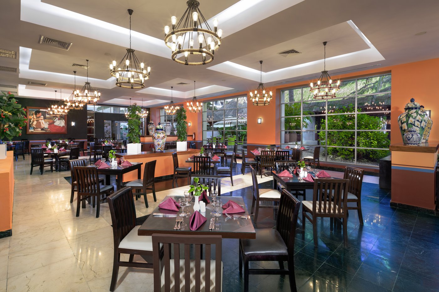 Gallery of Food & Beverage: Restaurant with tables and chairs at the hotel Grand Oasis Cancun.