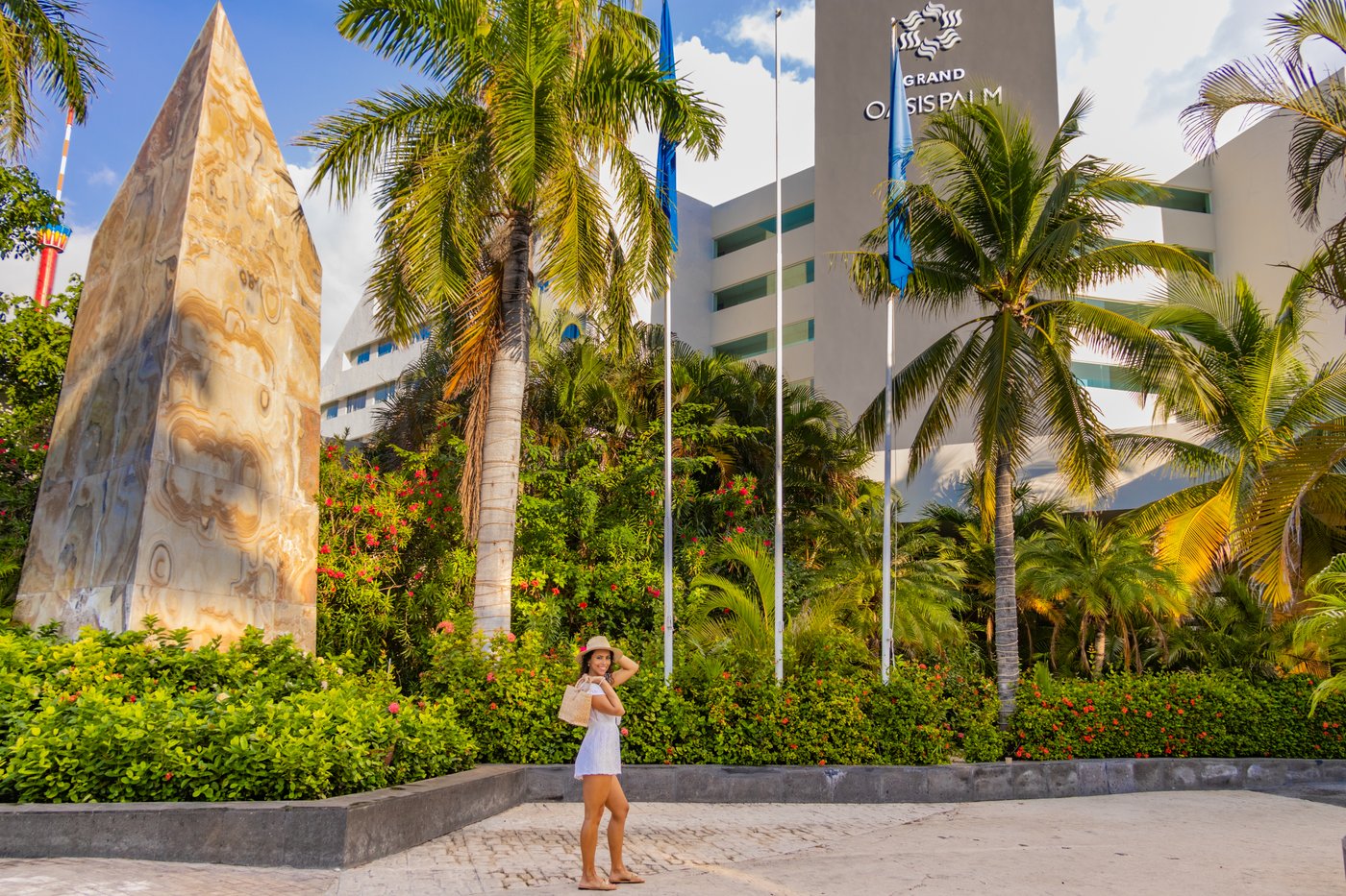 Person in a tropical garden at the hotel Grand Oasis Palm.