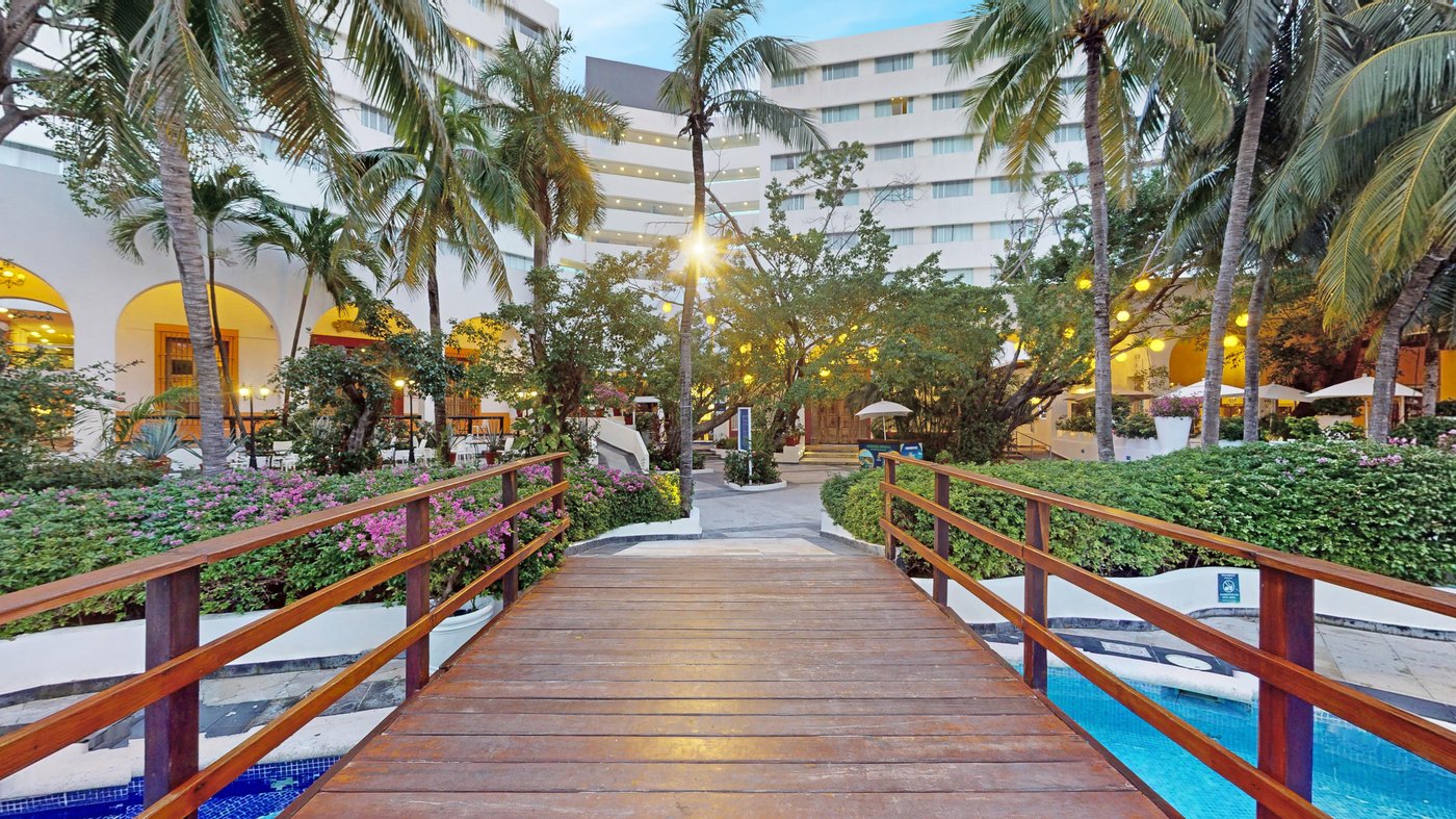 Wooden bridge over a pool at the hotel Grand Oasis Palm.
