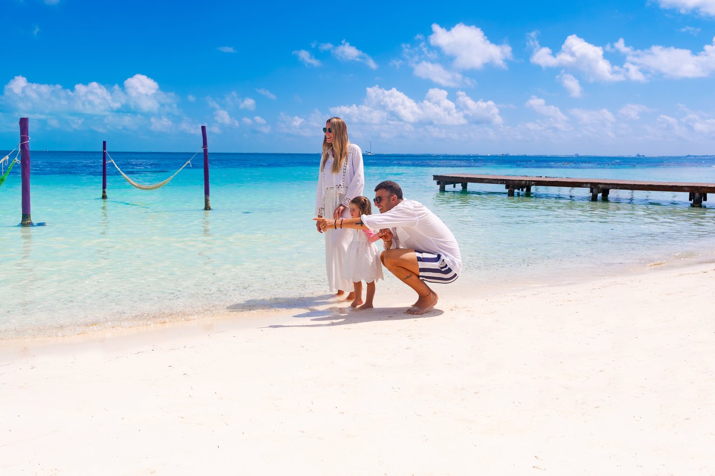 Pareja en un muelle en la praia do hotel The Sens Cancun.