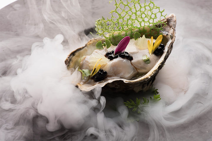 Ostiones a la rockefeller, servidos en Restaurante Careyes en Hotel The Pyramid at Grand Oasis